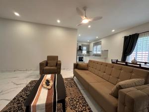 a living room with a couch and a chair at Heritage Community in Brufut