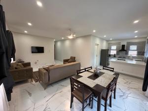 a living room with a dining table and a couch at Heritage Community in Brufut