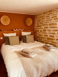 una camera da letto con un letto grande con due asciugamani sopra di Jas Tihou - Mas du tilleul a Le Beausset