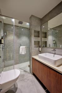 a bathroom with a tub and a sink and a shower at Hotel Karl Residency in Mumbai +23 photos