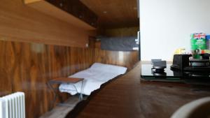 a room with a small bed in a wooden room at Sleep-in Beauty in Thakeham