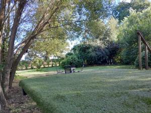 a park with a bench sitting in the grass at Sleep-in Beauty in Thakeham +5 photos