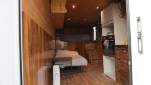a small room with a bed in a tiny house at Sleep-in Beauty in Thakeham