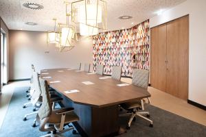 a large conference room with a long table and chairs at Hampton by Hilton Munich Airport South in Hallbergmoos