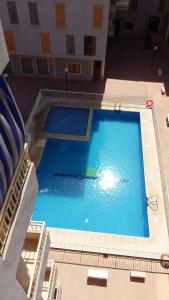 an overhead view of a large swimming pool in a building at Calle Santomera 17 in Torrevieja