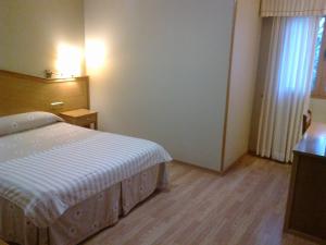 Postel nebo postele na pokoji v ubytování Hotel Anabel Baza