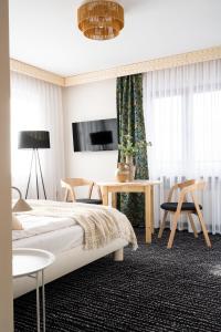a bedroom with a bed and a table and chairs at Willa Dunajec in Zakopane
