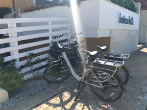 a bike parked next to a white fence at Residenza RoMa in Tropea