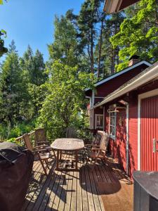 a patio with a table and chairs on a deck at Kutala Cottage in Kutala