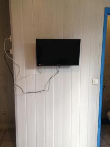 a flat screen tv hanging on a wall at Hôtel Cyrano Voltaire in Paris