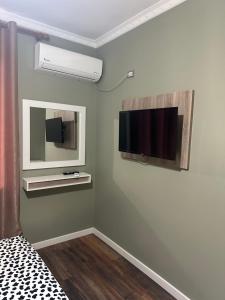 a room with a flat screen tv on a wall at Hotel, Bar, Restaurant Beni in Vlorë