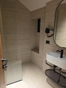 a bathroom with a sink and a mirror at Post Inn Hotel-New Bazaar in Tirana +50 photos