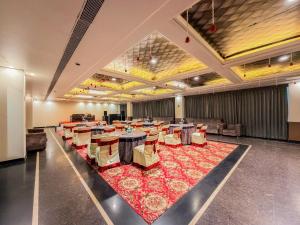 a large banquet hall with tables and chairs at Spree Hotel Meerut in Meerut
