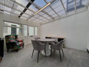 a living room with a table and chairs at Apartment in Omagh in Omagh