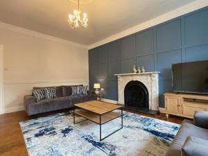 a living room with a couch and a fireplace at Apartment in Omagh in Omagh