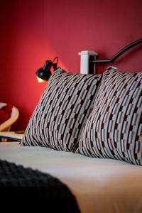 a bed with a black and white pillow and a lamp at Palm La Vie in Worcester