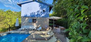 a villa with a swimming pool and a house at villa la chiesetta - private pool and Jacuzzi - Borgo Canapegna in Fabriano