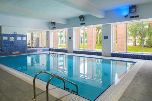 a large swimming pool with blue water at UHC Spa Aqquaria Family Complex in Salou