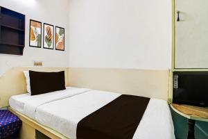 a bedroom with a bed and a flat screen tv at Hotel O Akash Namostay in Jamshedpur +21 photos