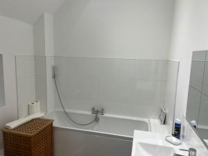 a bathroom with a tub and a sink and a bath tub at Glebe Barn in Cuxham +29 photos