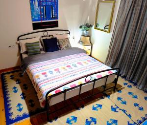 a bedroom with a bed and a rug on the floor at xanthi's sea front villas in Flámbouras