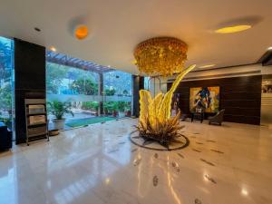 a large lobby with a large chandelier and a large room at Spree Hotel Meerut in Meerut