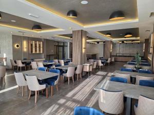 a restaurant with tables and chairs in a room at Harmony, Residence Hill A85 in Kopaonik