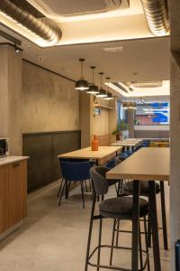 a conference room with tables and chairs in an office at Hostel Nixar in Almería