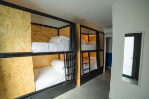 a room with three bunk beds in a room at Hostel Nixar in Almería
