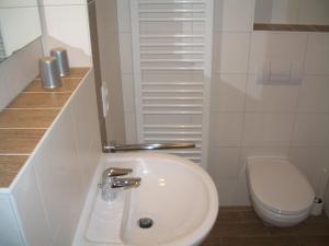 a bathroom with a white sink and a toilet at Ferienwohnung Rerik in Rerik