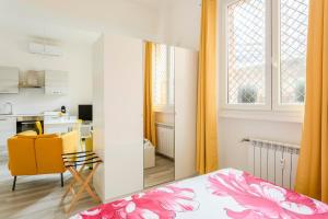 a bedroom with a bed and a table and a kitchen at AfforiCentro in Milan