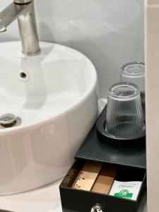 a bathroom with a sink and a box with cups at Ancor Homestay in Phan Rang–Tháp Chàm +31 photos