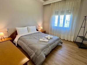 a bedroom with a bed with two towels on it at Mary's Villa in Xanthi