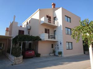 a house with a car parked in front of it at Viola Cavtat Rooms in Cavtat