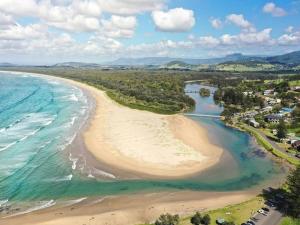 an aerial view of a beach next to the ocean at Beside the Seaside Gerroa Dual Family Living in Gerroa