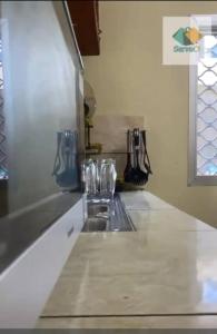 a kitchen with a sink and a counter top at Appartement in Bonabéri