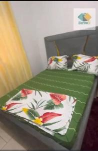 two beds with pillows on them in a room at Appartement in Bonabéri