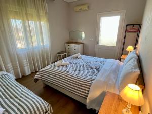a bedroom with a bed with two towels on it at Mary's Villa in Xanthi