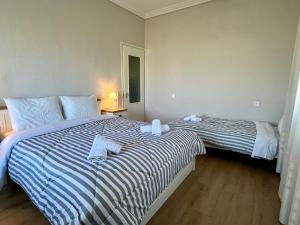 a bedroom with two beds with towels on them at Mary's Villa in Xanthi