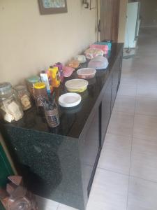 a black counter with several bowls of food on it at Pousada Rural Veredas in Piancó +11 photos