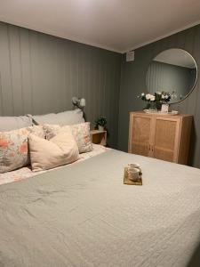 a bedroom with a large bed and a mirror at Furnishe outhouse in Bergen