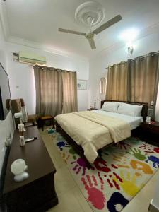 a bedroom with a large bed and a rug at Suitehub in Ikeja