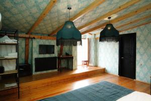 a bedroom with a bed and a tv and a ceiling at Hotel Memoire Kutaisi in Kutaisi