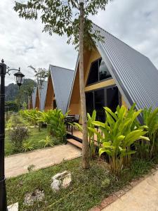a house with a metal roof on top of it at Nature Resort Vangvieng in Vang Vieng
