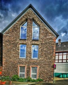 a brick building with four windows on the side of it at Casa Manderscheid in Manderscheid