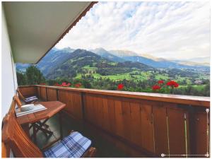 a balcony with a table and a view of a valley at Fewo-Egger-Thalmann in Virgen