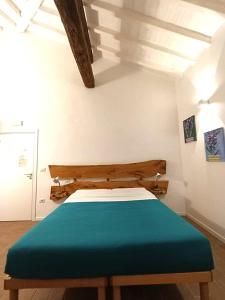 a bedroom with a bed with a green blanket at Agriturismo Parco della Chiusa in Casalecchio di Reno +34 photos