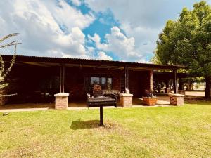 a house with a pavilion in the grass at The Grove in Potchefstroom