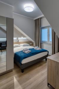 Postel nebo postele na pokoji v ubytování Apartamenty u Maślanki + 87 fotografií