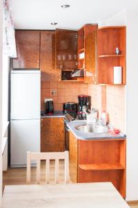 a small kitchen with a sink and a refrigerator at Lastekodu Apartment in Tallinn